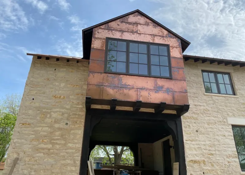 Copper metal panel facade on a stone building for Roof Repair in Spanish Fork
